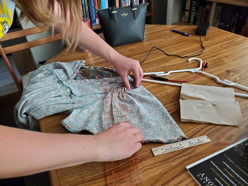 Emma working on the shirt